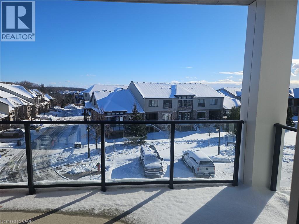 Snow covered back of property with a residential view - 249 Grey Silo Road Unit# 301, Waterloo, ON - Outdoor With Balcony With View