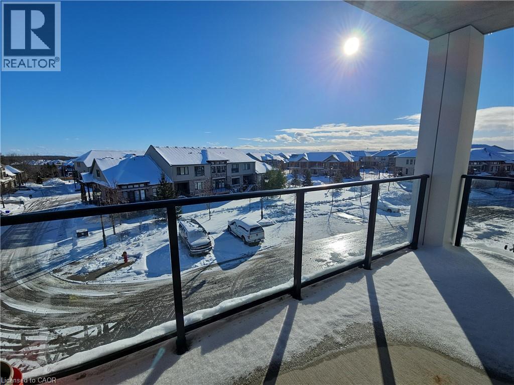 Snow covered back of property with a residential view - 249 Grey Silo Road Unit# 301, Waterloo, ON - Outdoor With Balcony With View