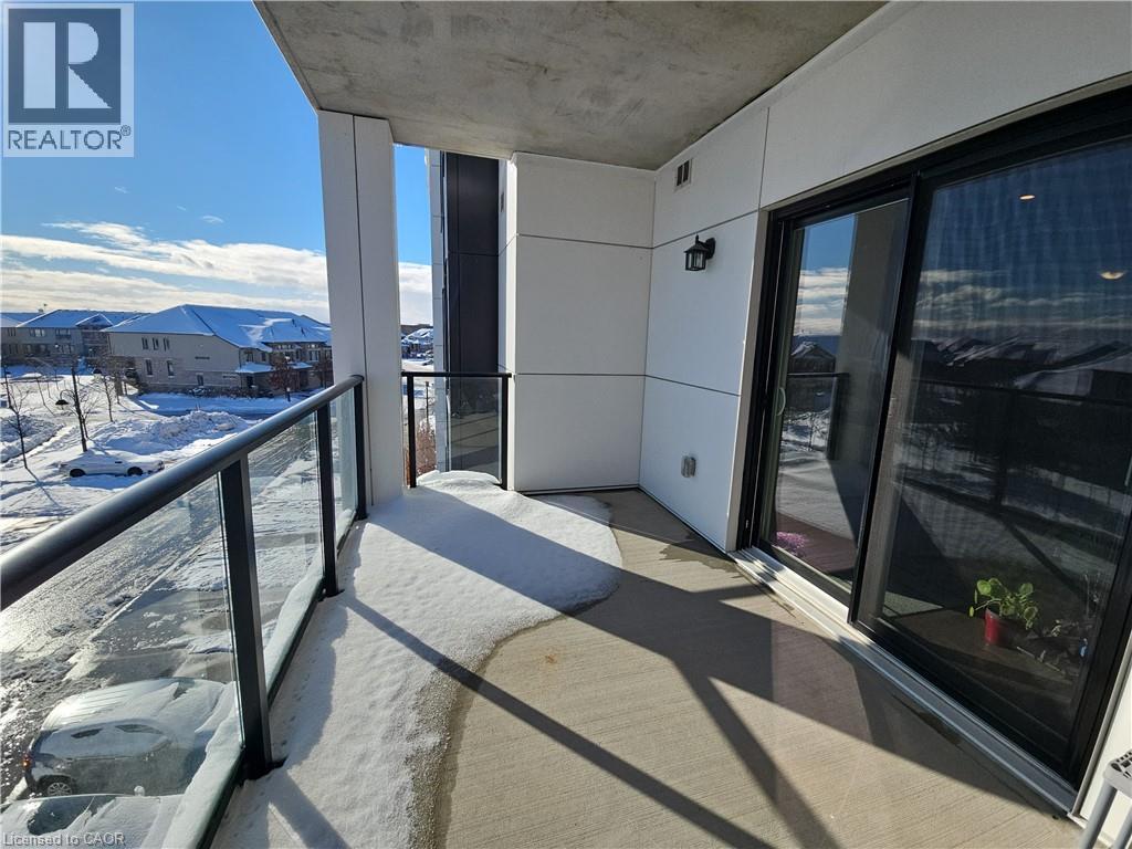 View of snow covered back of property - 249 Grey Silo Road Unit# 301, Waterloo, ON - Outdoor With Balcony With Exterior
