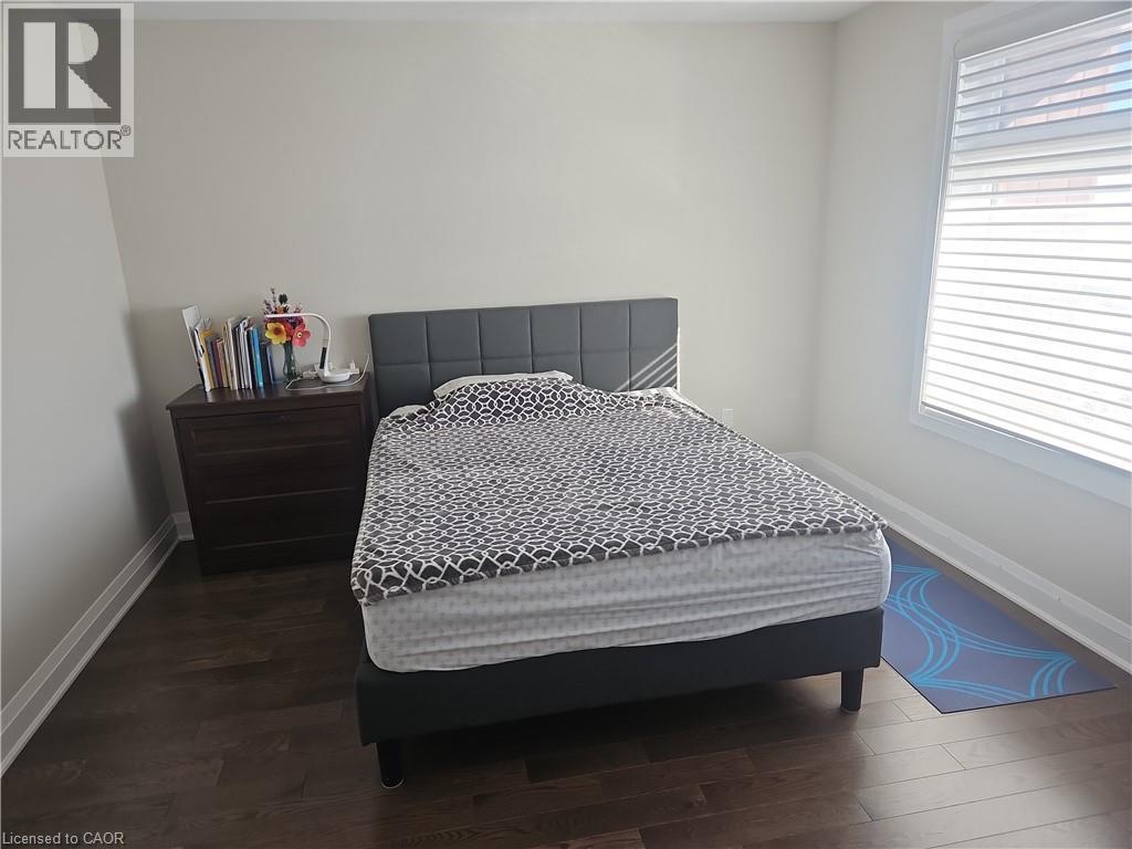 Bedroom featuring baseboards and dark wood-type flooring - 249 Grey Silo Road Unit# 301, Waterloo, ON - Indoor Photo Showing Bedroom