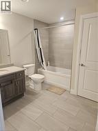 Full bathroom with shower / tub combo, vanity, and recessed lighting -
