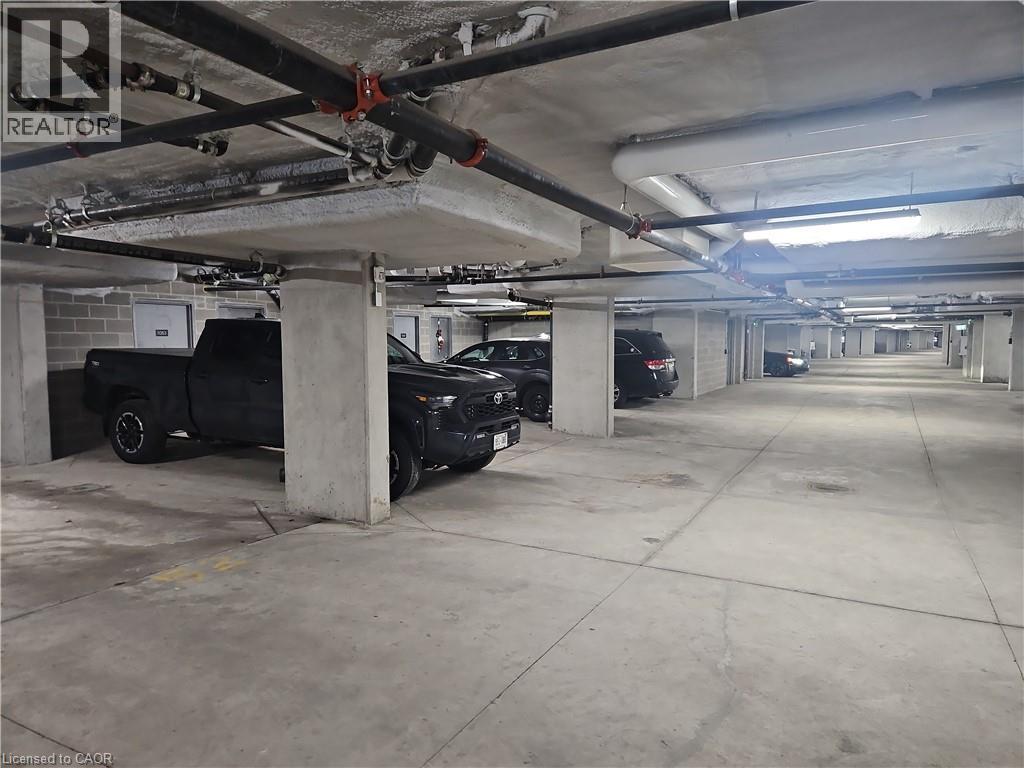 View of parking garage - 249 Grey Silo Road Unit# 301, Waterloo, ON - Indoor Photo Showing Garage