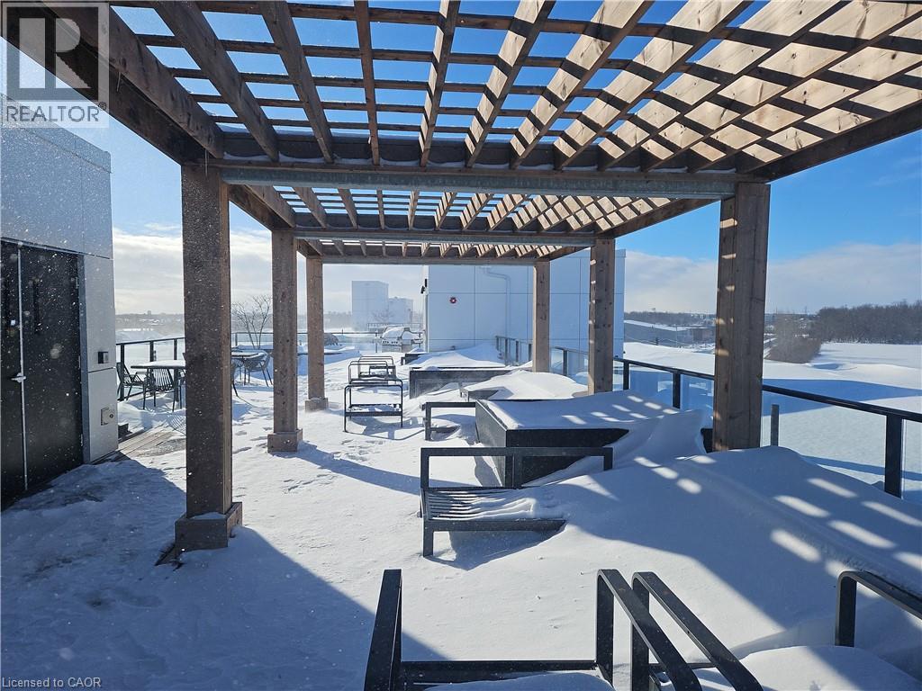 Snow covered patio with a pergola and a patio - 249 Grey Silo Road Unit# 301, Waterloo, ON - Outdoor