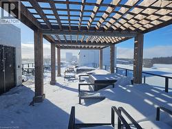 Snow covered patio with a pergola and a patio -