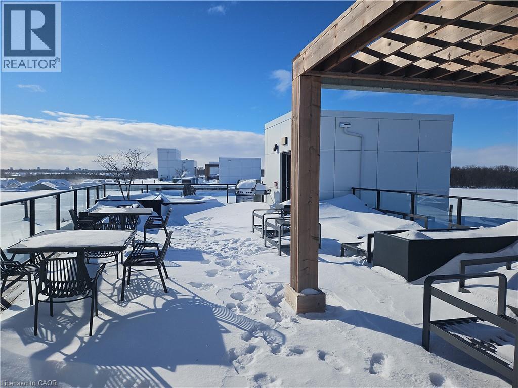 Snow covered patio featuring a patio area, area for grilling, and outdoor dining area - 249 Grey Silo Road Unit# 301, Waterloo, ON - Outdoor