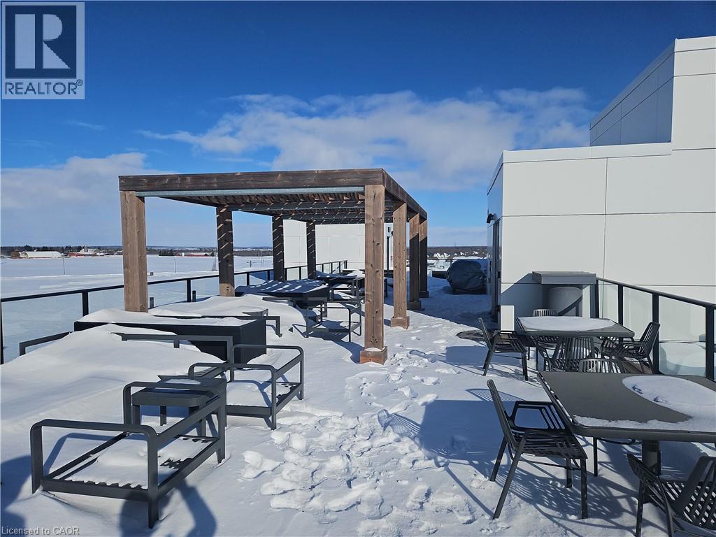 Snow covered patio with a patio and outdoor dining space - 249 Grey Silo Road Unit# 301, Waterloo, ON - Outdoor With Deck Patio Veranda