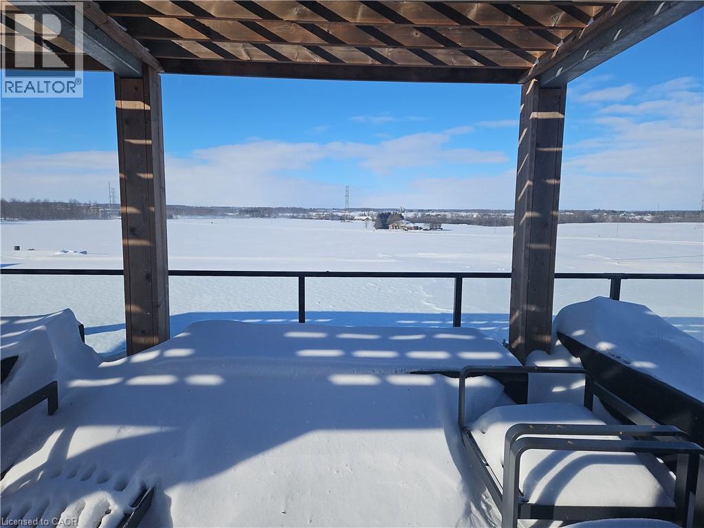 View of snow covered patio - 249 Grey Silo Road Unit# 301, Waterloo, ON - Outdoor With Body Of Water With Balcony With View