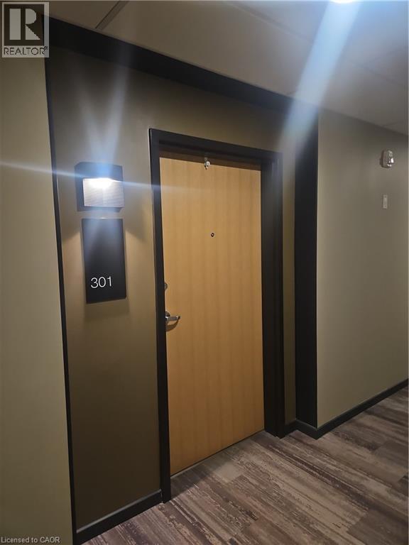 Hall featuring dark wood-type flooring - 249 Grey Silo Road Unit# 301, Waterloo, ON - Indoor Photo Showing Other Room