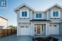 View of front of home featuring an attached garage and concrete driveway -