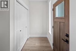 Corridor with light wood-style floors and baseboards -