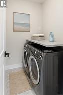 Laundry room featuring baseboards and independent washer and dryer -