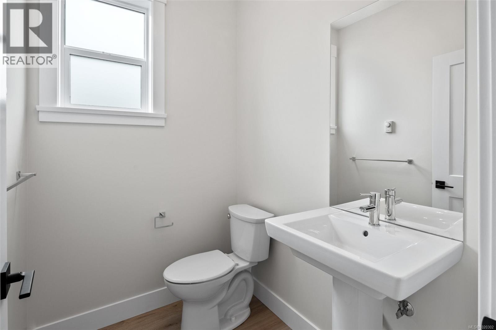 Bathroom with wood finished floors and toilet - A 6521 Noblewood Pl, Sooke, BC - Indoor Photo Showing Bathroom