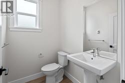 Bathroom with wood finished floors and toilet -