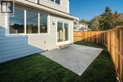 Fenced backyard with a patio area -