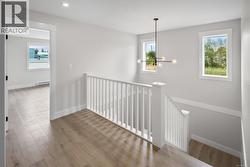 Hallway with an upstairs landing, wood finished floors, a baseboard radiator, a chandelier, and recessed lighting -