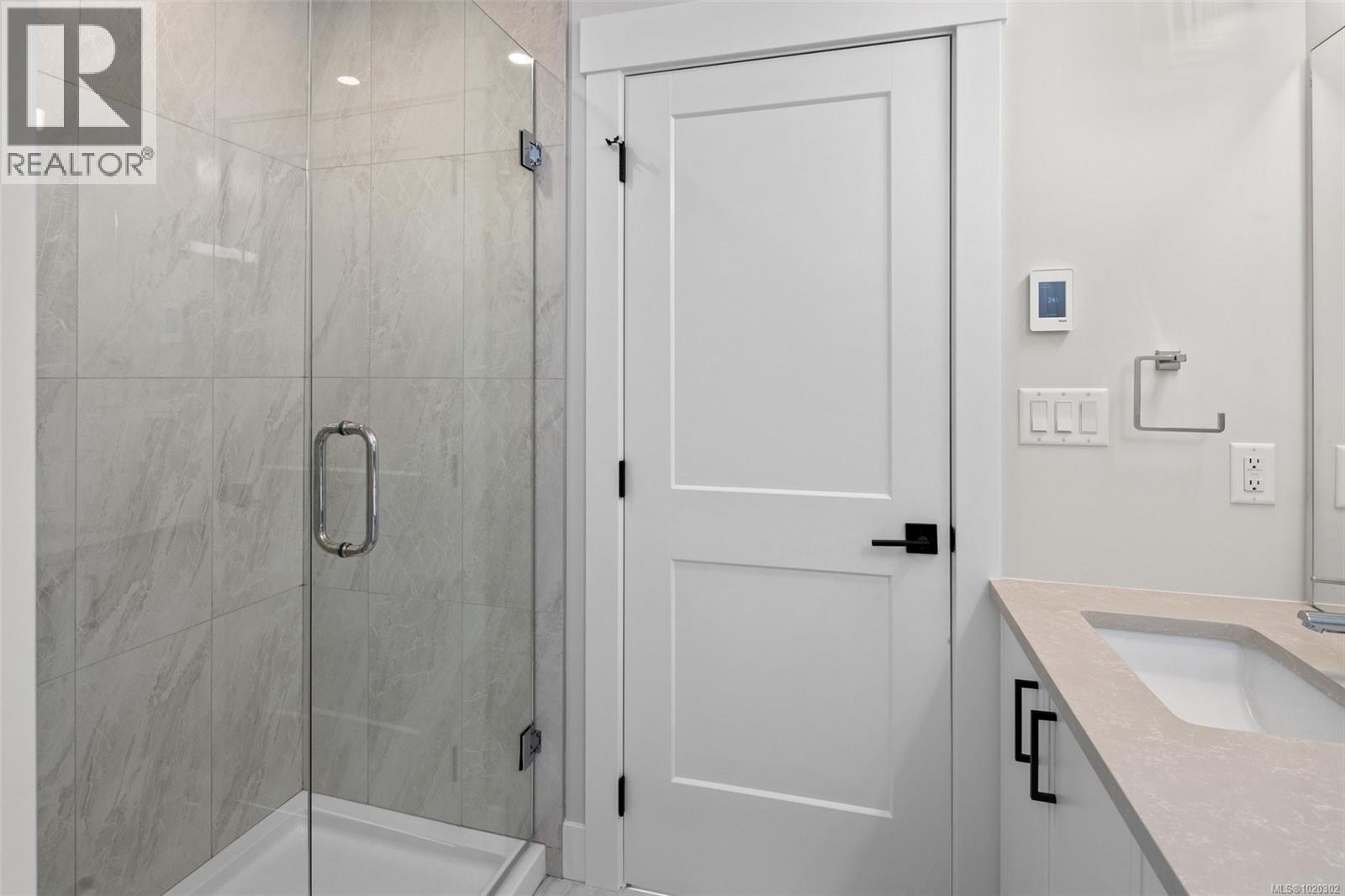 Bathroom featuring vanity and a marble finish shower - A 6521 Noblewood Pl, Sooke, BC - Indoor Photo Showing Bathroom