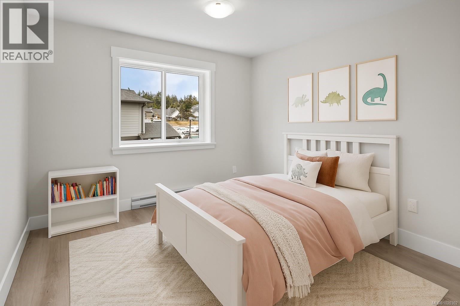 Bedroom with light wood-style floors and baseboard heating - A 6521 Noblewood Pl, Sooke, BC - Indoor Photo Showing Bedroom
