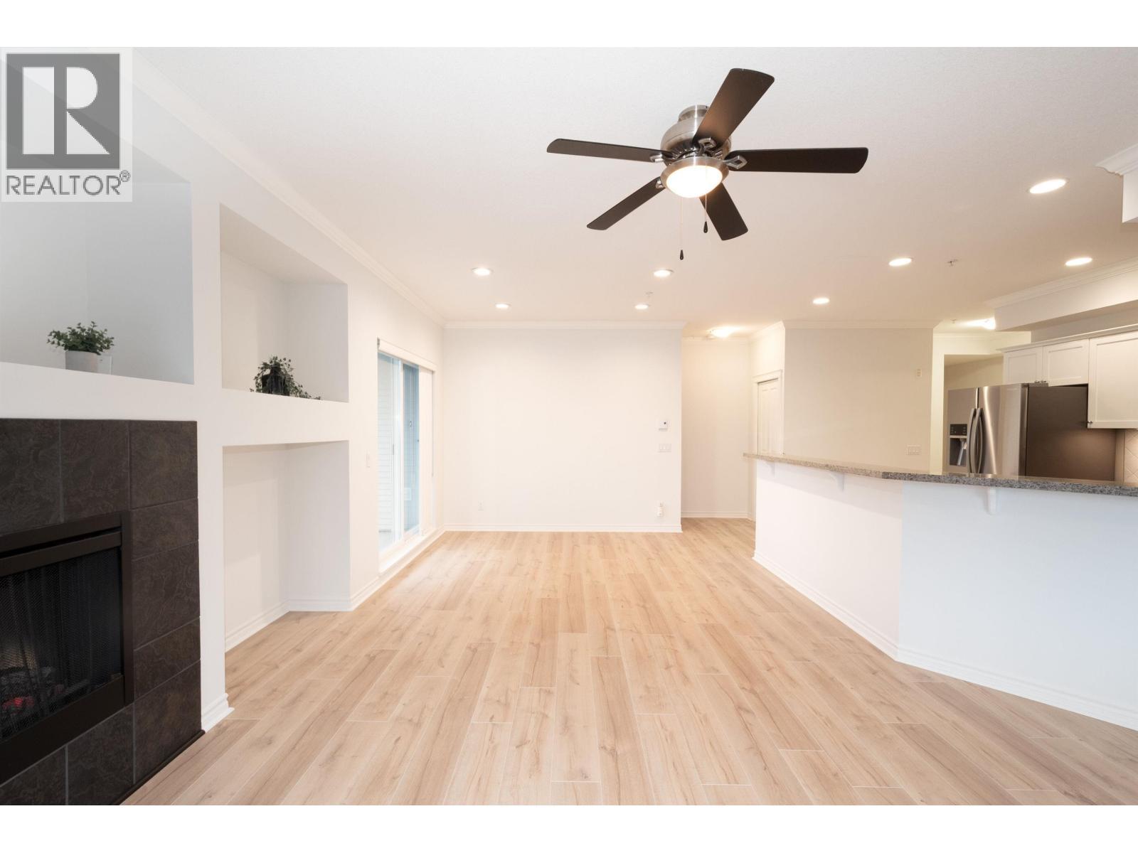 202 12090 227 Street, Maple Ridge, BC - Indoor Photo Showing Living Room With Fireplace