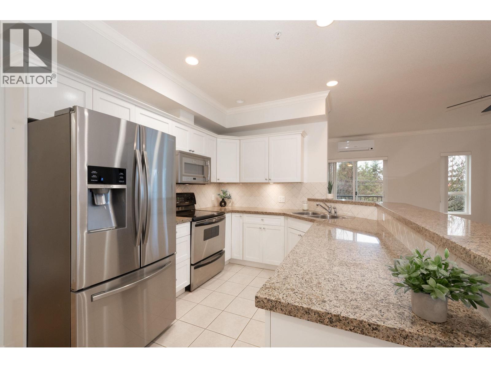 202 12090 227 Street, Maple Ridge, BC - Indoor Photo Showing Kitchen With Stainless Steel Kitchen With Double Sink