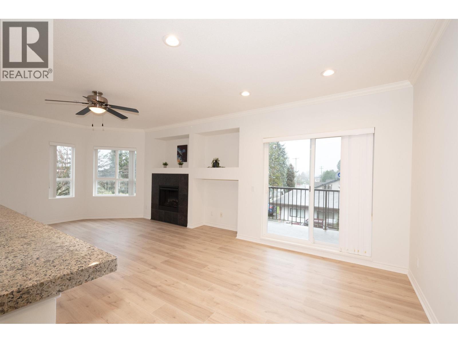 202 12090 227 Street, Maple Ridge, BC - Indoor Photo Showing Living Room With Fireplace