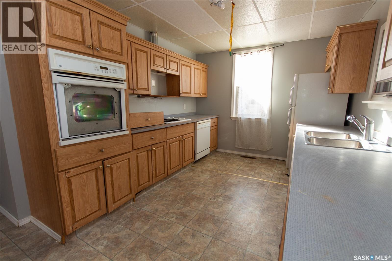 1131 104Th Street, North Battleford, SK - Indoor Photo Showing Kitchen With Double Sink