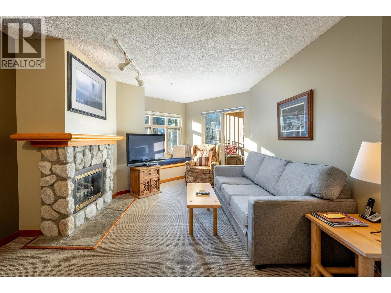 322 2050 Lake Placid Road, Whistler, BC - Indoor Photo Showing Living Room With Fireplace