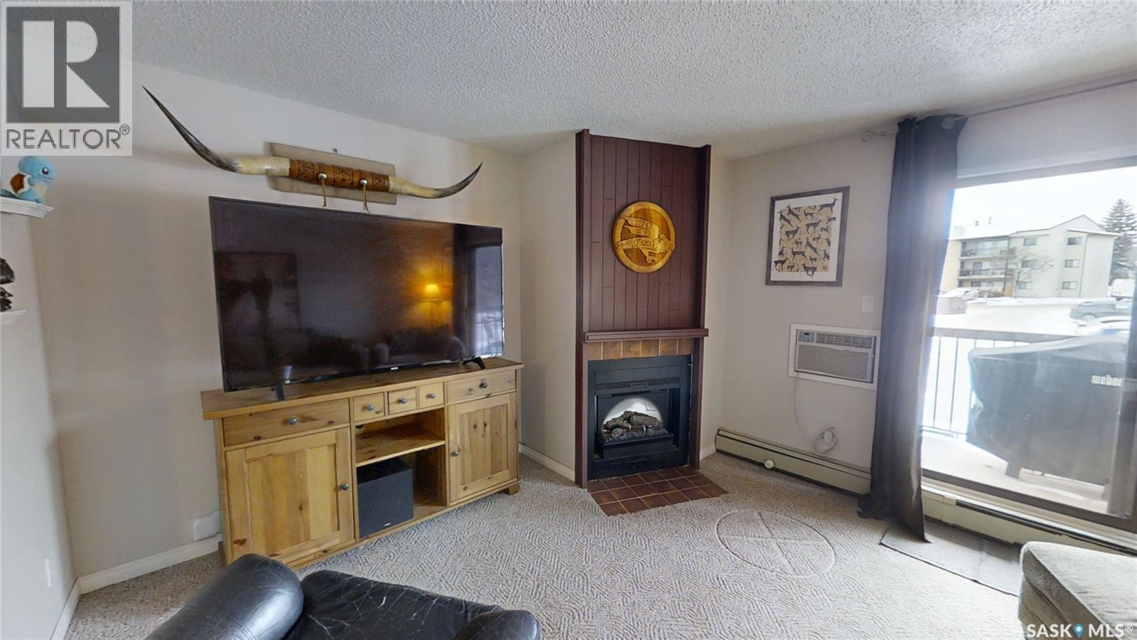201 245 Kingsmere Boulevard, Saskatoon, SK - Indoor Photo Showing Other Room With Fireplace