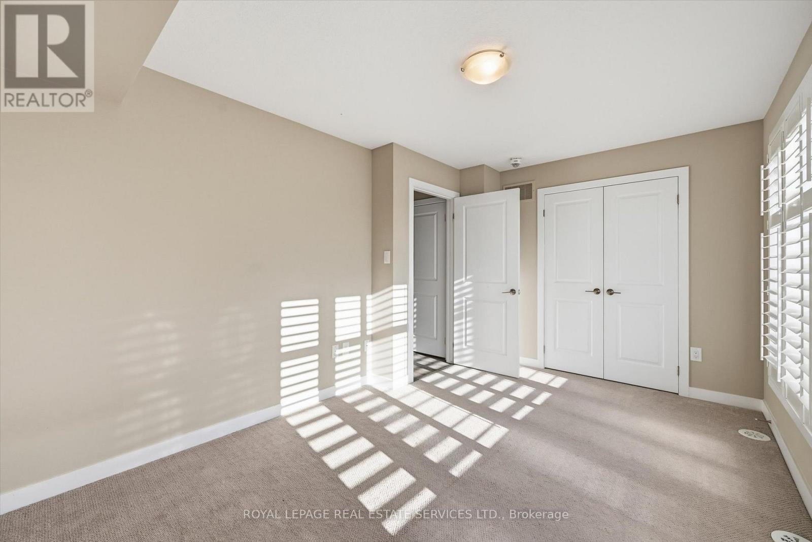 Generous Second Bedroom with Plush Broadloom - 85 Esplanade Lane, Grimsby, ON - Indoor Photo Showing Other Room