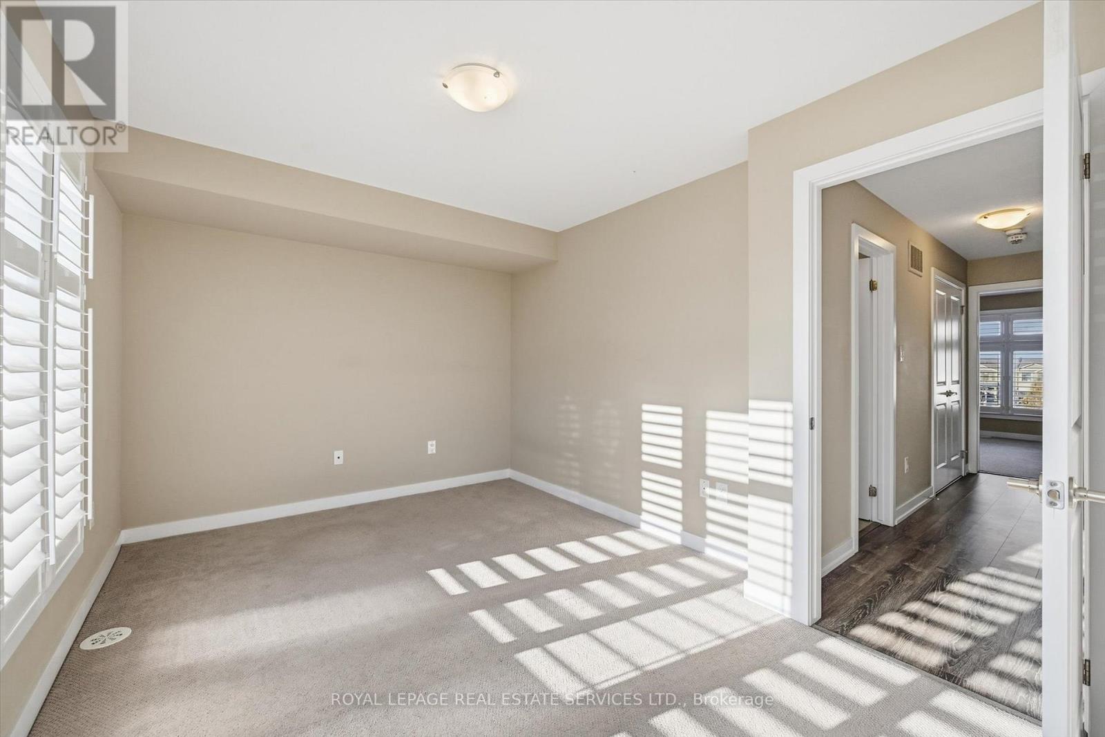 Generous Second Bedroom with Plush Broadloom - 85 Esplanade Lane, Grimsby, ON - Indoor Photo Showing Other Room
