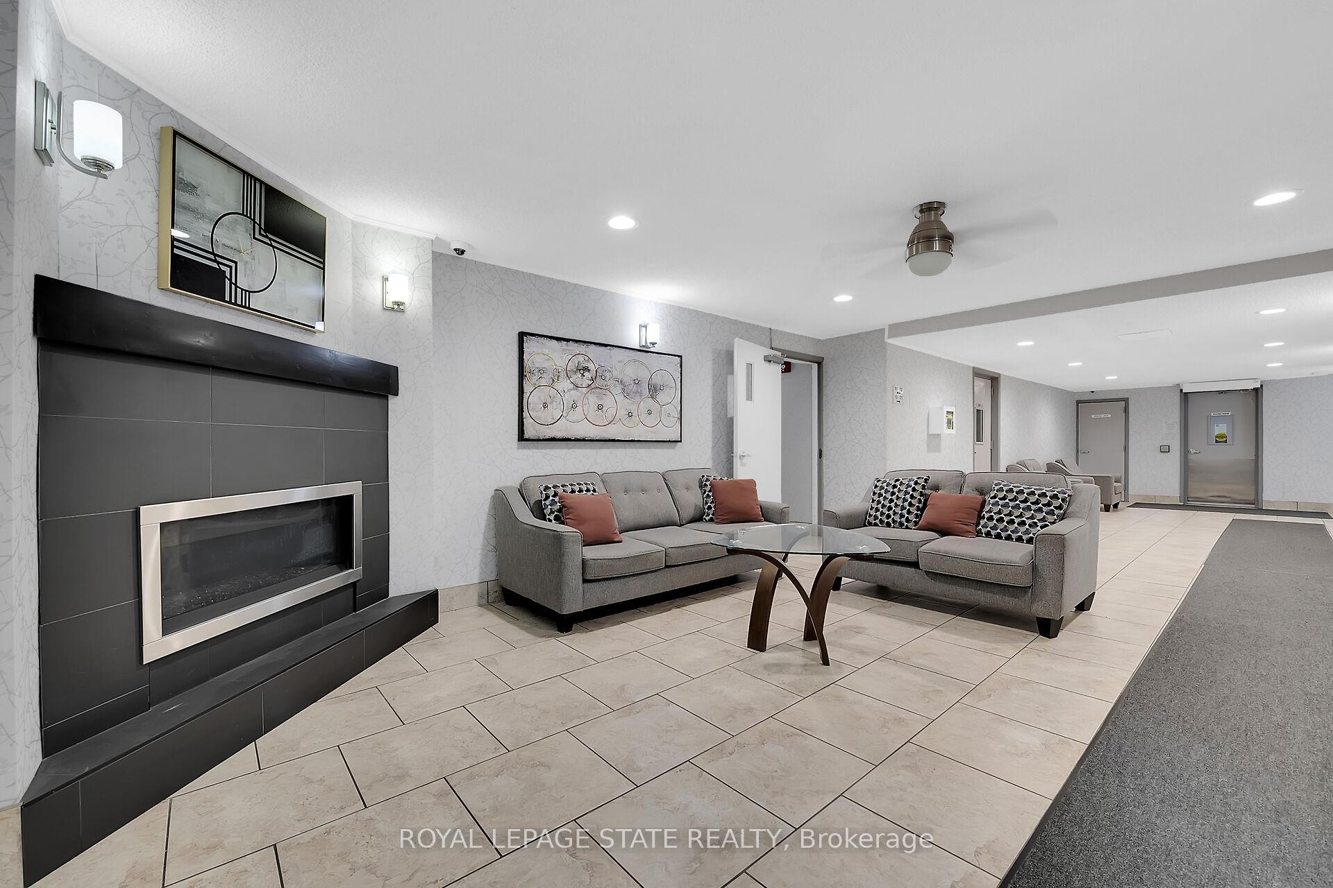 220-198 Scott Street, St. Catharines, ON - Indoor With Fireplace