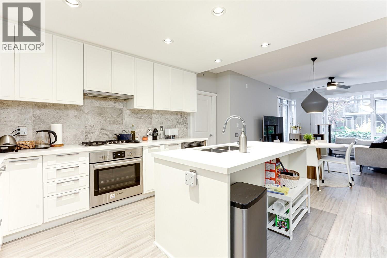 108 3188 Riverwalk Avenue, Vancouver, BC - Indoor Photo Showing Kitchen With Double Sink With Upgraded Kitchen