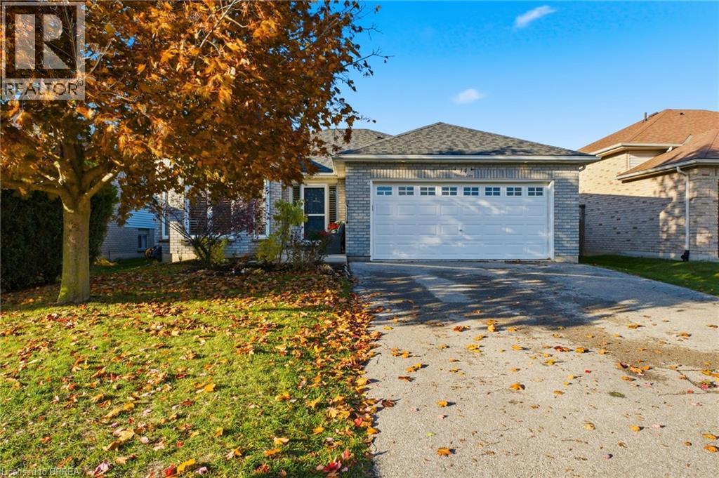 Ranch-style house with asphalt driveway, brick siding, a garage, and a front lawn - 14 Dunton Lane, Paris, ON - Outdoor