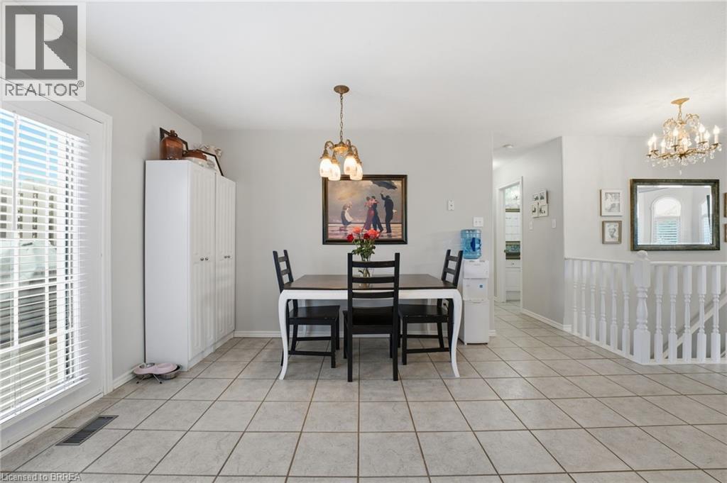 Dining space featuring a chandelier and light tile patterned floors - 14 Dunton Lane, Paris, ON - Indoor Photo Showing Dining Room