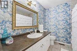 Bathroom featuring curtained shower, vanity, and light tile patterned floors -
