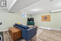 Living room with light wood-style flooring and a textured ceiling -