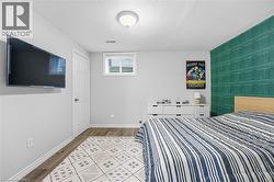 Bedroom featuring light wood finished floors and an accent wall -