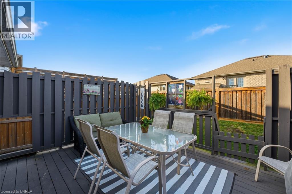 Wooden terrace with outdoor dining space and a fenced backyard - 14 Dunton Lane, Paris, ON - Outdoor With Deck Patio Veranda With Exterior