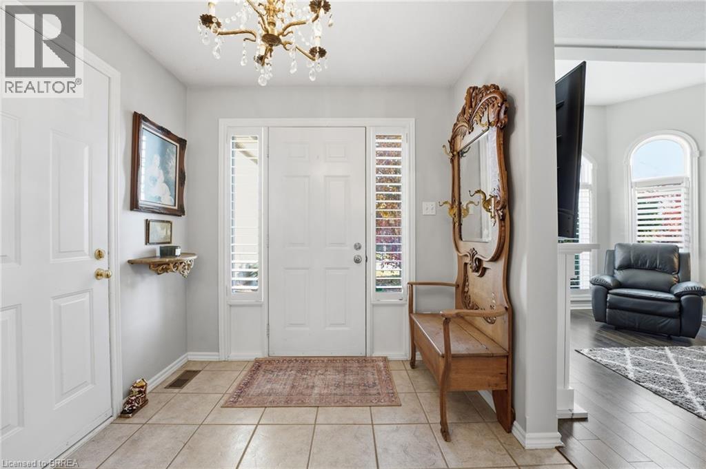 Foyer with plenty of natural light, a chandelier, and light tile patterned floors - 14 Dunton Lane, Paris, ON - Indoor Photo Showing Other Room