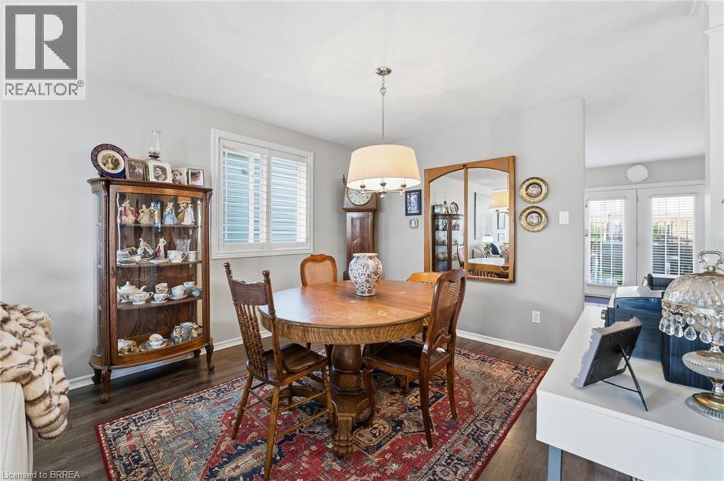 Dining room with dark wood-style floors and healthy amount of natural light - 14 Dunton Lane, Paris, ON - Indoor Photo Showing Dining Room