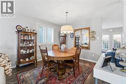 Dining room with dark wood-style floors and healthy amount of natural light -