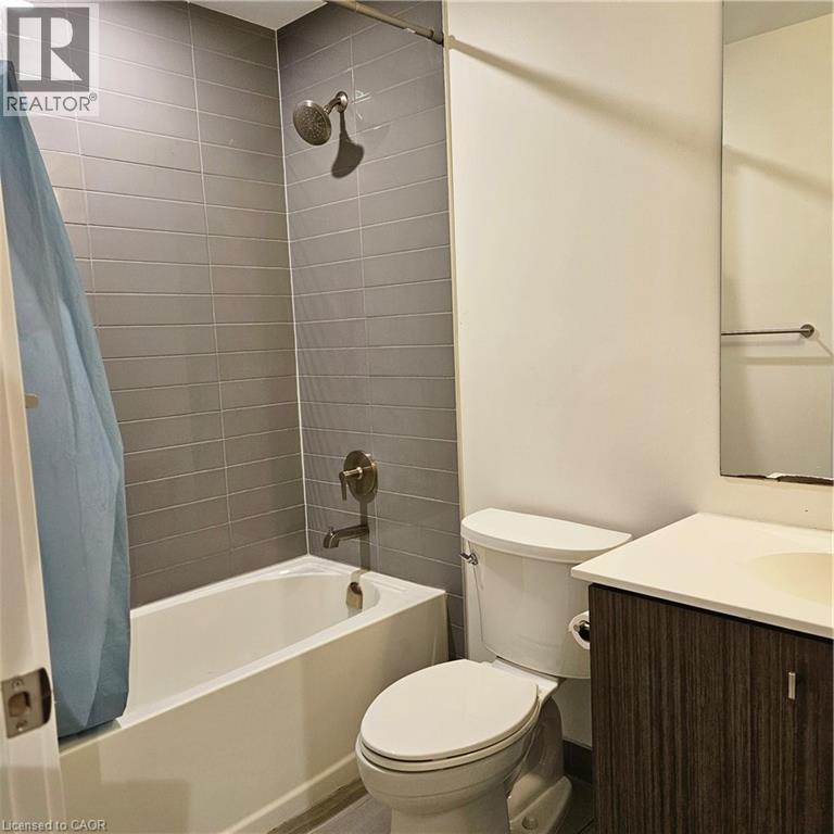 Full bathroom with vanity, toilet, and shower / bathtub combination with curtain - 5 Wellington Street S Unit# 703, Kitchener, ON - Indoor Photo Showing Bathroom
