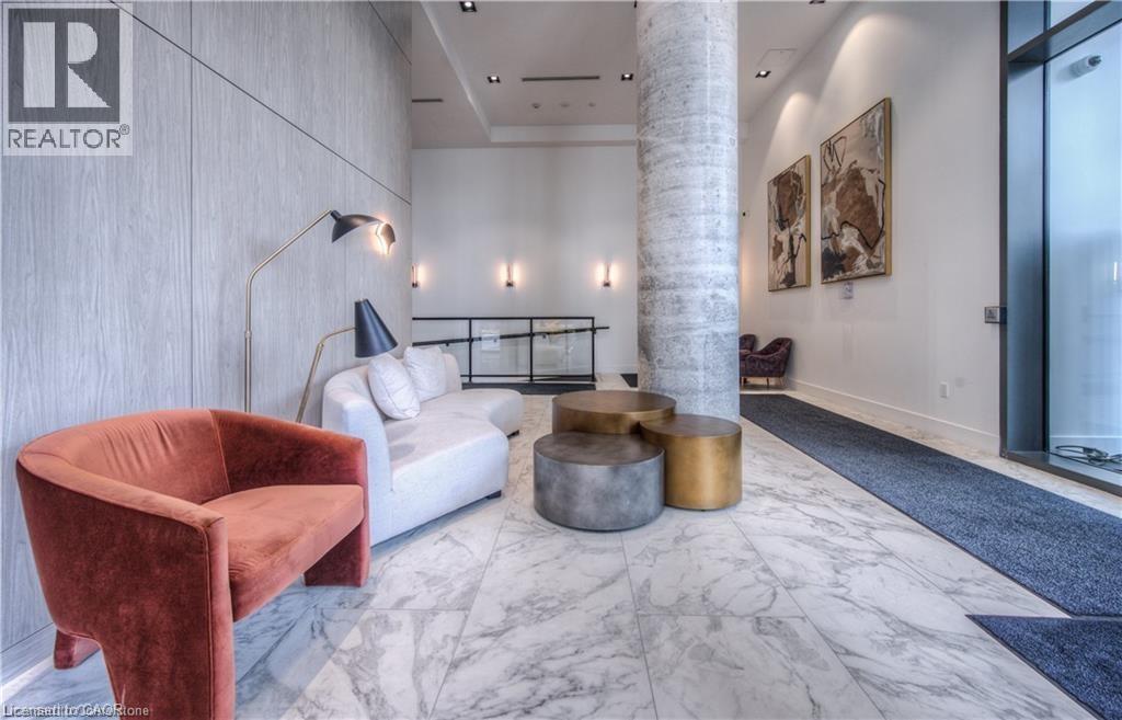 Living area with decorative columns and a towering ceiling - 5 Wellington Street S Unit# 703, Kitchener, ON - Indoor