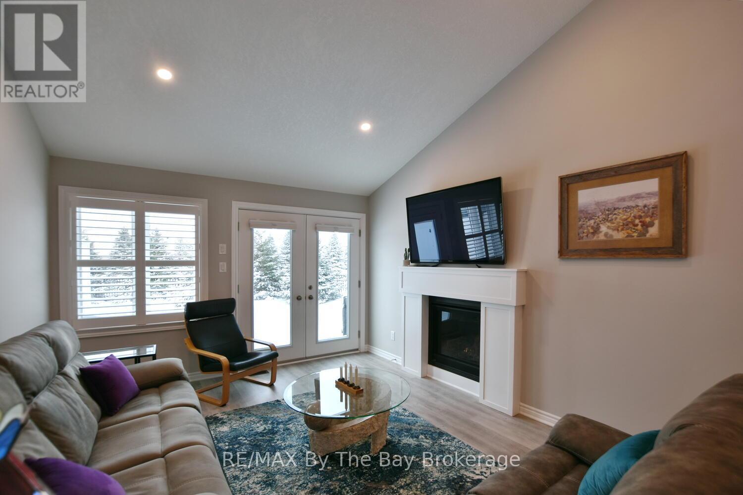 Living Area with Gas Fireplace and French Doors - 30 Ivy Crescent, Wasaga Beach, ON - Indoor Photo Showing Living Room With Fireplace