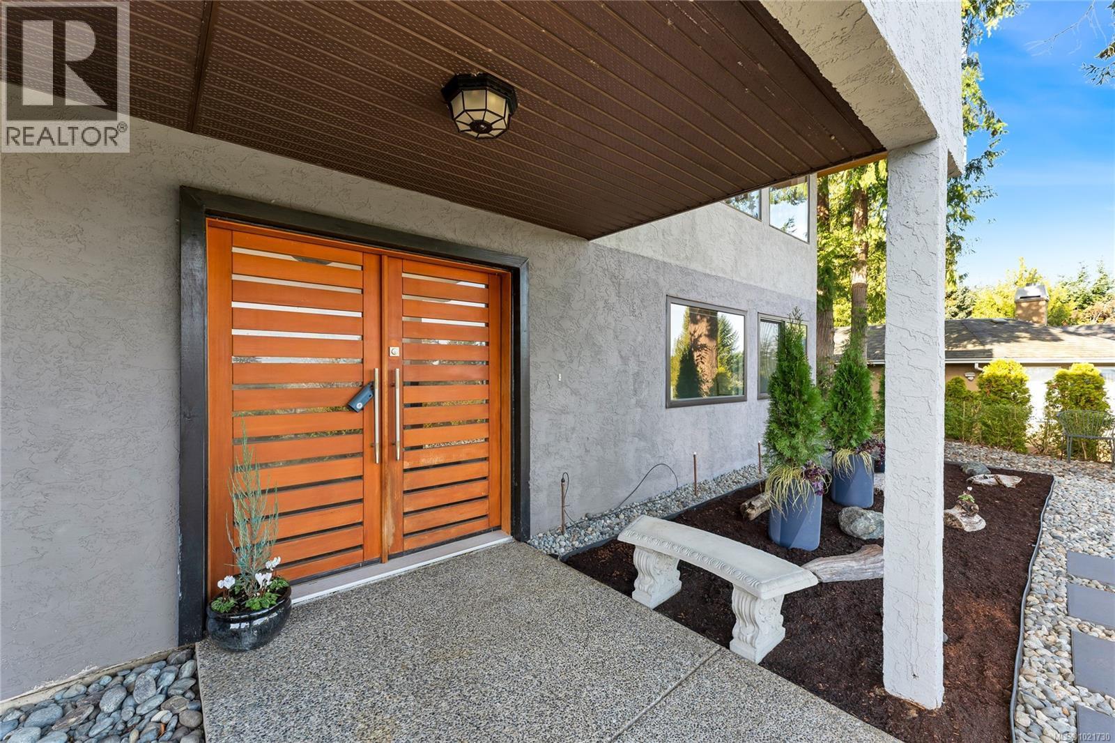 View of front entry and a patio area - 5198 Beckton Rd, Saanich, BC - Outdoor With Exterior