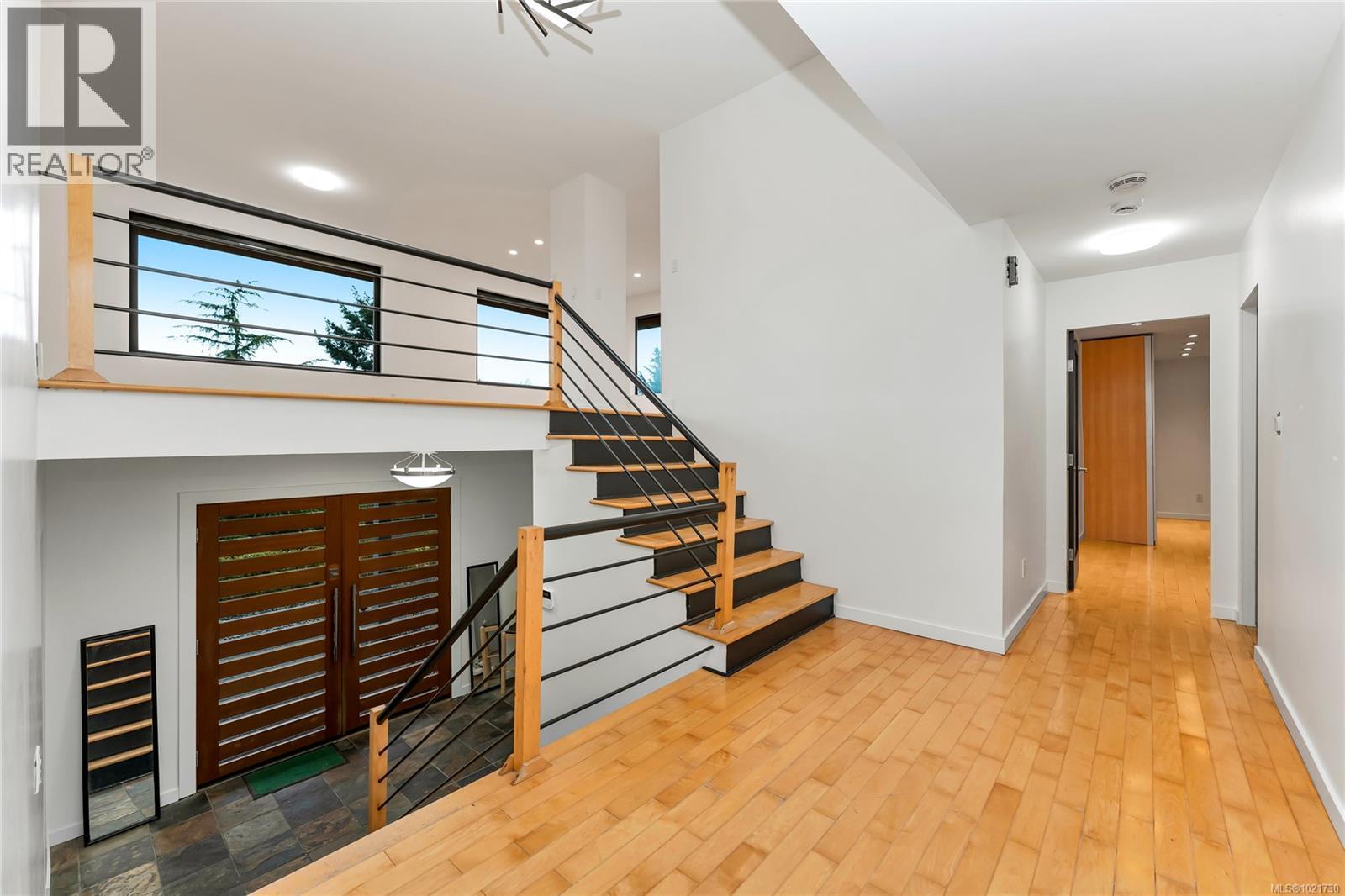 Stairs from lower level to main (bedroom) level and upper - 5198 Beckton Rd, Saanich, BC - Indoor Photo Showing Other Room