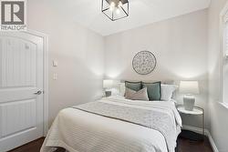Bedroom featuring dark wood-type flooring and baseboards -
