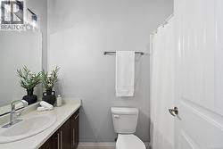 Bathroom featuring curtained shower and vanity -