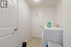 Laundry room with washer and clothes dryer and baseboards -