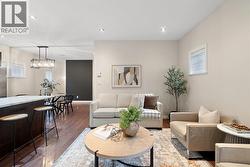 Living room featuring wood finished floors, recessed lighting, and a textured ceiling -