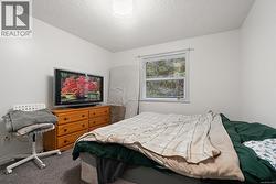 Bedroom with carpet floors and a textured ceiling -